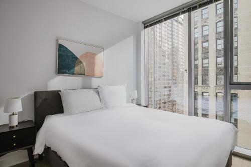 A bed or beds in a room at Blueground The Loop pool gym nr park CHI-1187