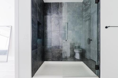 a bathroom with a shower with a toilet in it at Blueground Downtown pool AC nr Capitol ATX-294 in Austin