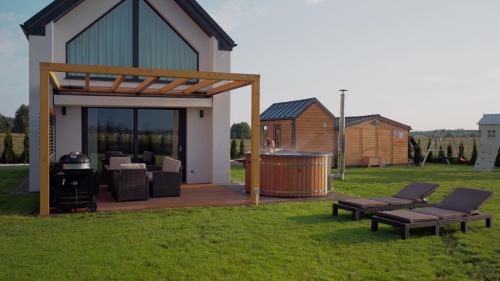 a backyard with a gazebo and a grill at Sea & Sun in Wierzchucino