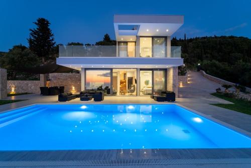a house with a swimming pool in front of it at Zenvillas in Lefkada Town