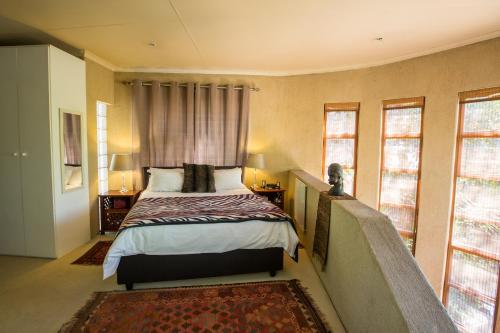 A bed or beds in a room at Moonflower Cottages