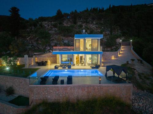 a house with a swimming pool in front of it at Zenvillas in Lefkada Town