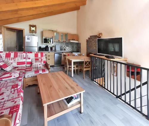 a living room with a couch and a table at Maison chaleureuse à Courchevel avec vue sur montagnes in Courchevel