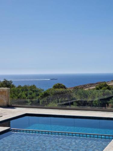 a swimming pool with a view of the ocean at Mnar Park aqua park in Tangier