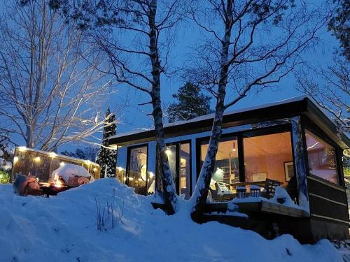 a house covered in snow at night with lights at fjord : oslo in Nordstrand