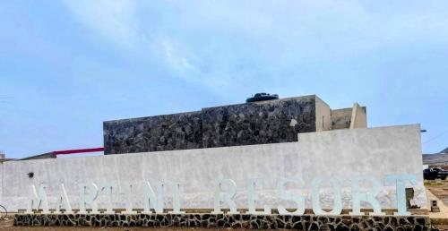 a building with a sign in front of it at Beach House in Calhau