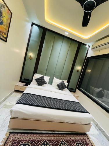 a bedroom with a bed with a large headboard at Taj Dream A Luxury Hotel - Agra in Agra