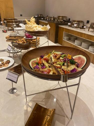 a table with a plate of food on a stand at Hotel Rewa Ladakh in Leh