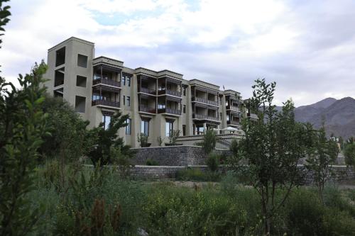 a rendering of a building with mountains in the background at Hotel Rewa Ladakh in Leh