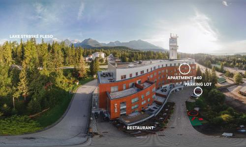 an aerial view of a building with a clock tower at Štrbské Pleso Apartmán Oliver #40 in Štrbské Pleso