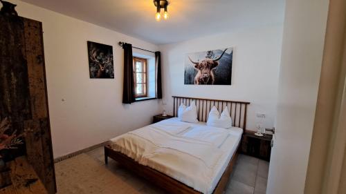 a bedroom with a bed with a deer on the wall at Haus.1800 in Altenmarkt im Pongau