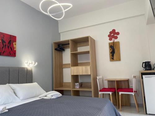 a bedroom with a bed and a table and chairs at Cosy studio 2 in Stoupa in Stoupa