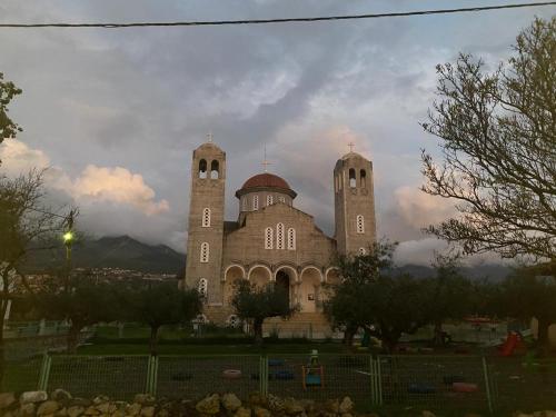 a large building with two towers on top of it at Cosy studio 2 in Stoupa in Stoupa