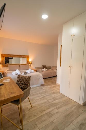 Ένα ή περισσότερα κρεβάτια σε δωμάτιο στο Center Suites San Eloy