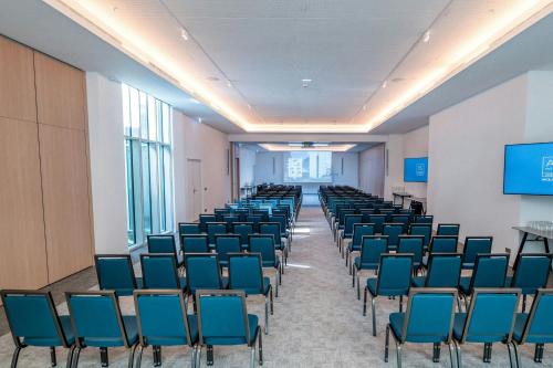an empty room with chairs and a screen at AC Hotel by Marriott Nice in Nice