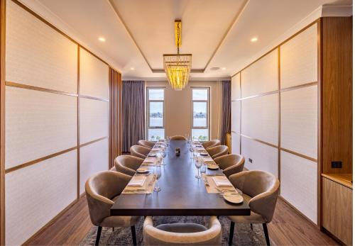 a long dining room with a long table and chairs at Duxton Hotel Perth in Perth