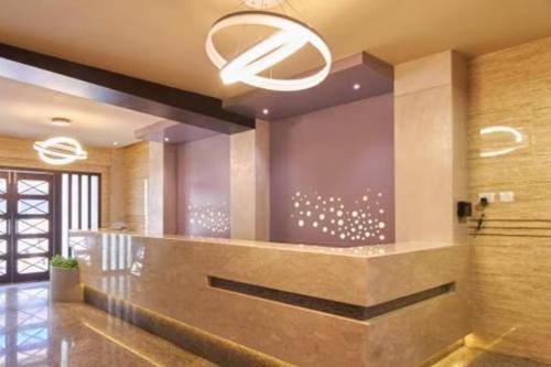 a lobby with a reception counter and a chandelier at Hotel Udupi Residency near Shri Krishna Mata, Udupi in Udupi