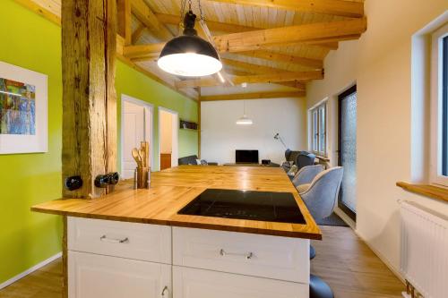 a kitchen with a wooden counter top and green walls at Fewo am Flämingrand in Zahna-Elster