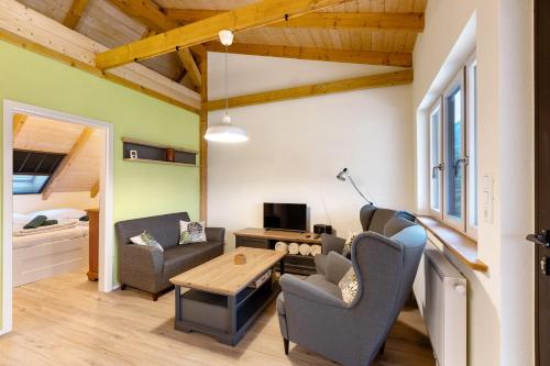 a living room with chairs and a table and a couch at Fewo am Flämingrand in Zahna-Elster