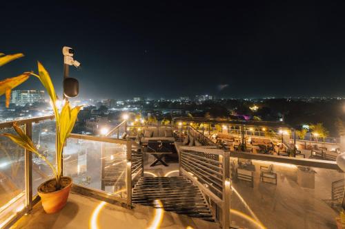 a balcony with a view of a city at night at D Horizon Hotel & Restaurant in Jodhpur