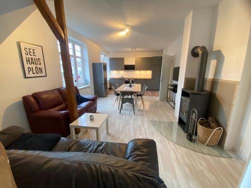 a living room with a couch and a living room with a fireplace at Seehaus Plön in Plön