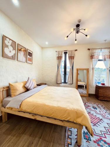 a bedroom with a large bed and a window at The Monhi Da Lat City in Xuan An