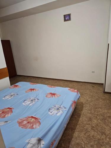 a bed with a blue sheet with fish on it at Ayg Hotel and Sport Complex Ararat in Davalinskiy Tsemzavod