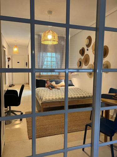 a young girl laying on a bed in a bedroom at Casa del Sombrero Los Locos beach in Torrevieja