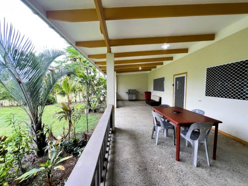 an office with a table and chairs on a balcony at Muri Homeland Villa in Rarotonga