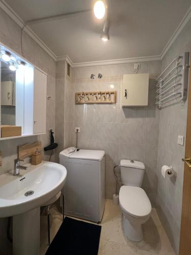 a bathroom with a white toilet and a sink at Casa del Sombrero Los Locos beach in Torrevieja