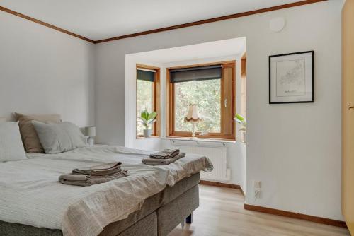 a bedroom with a large bed with towels on it at The Copper Cottage in Löddeköpinge