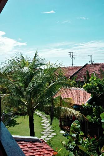 a view of a yard with palm trees and houses at Dreamville Beach Homestay in Phu Yen