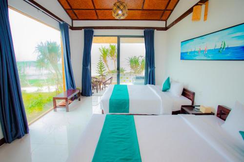 Postel nebo postele na pokoji v ubytování Adora Bay Ke Ga Beach Resort