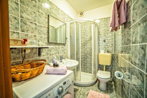 a bathroom with a sink and a toilet and a tub at Apartment Iva in Rovinj
