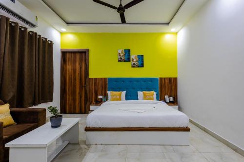 a bedroom with a king sized bed and a couch at Lime Tree Hotel and Banquet Vrindavan in Vrindāvan