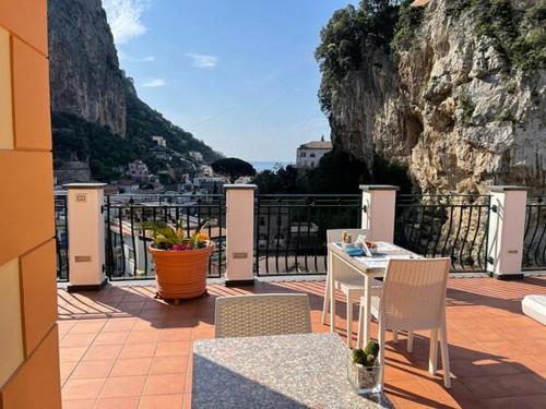 a patio with a table and chairs on a balcony at B&B Valentì in Amalfi