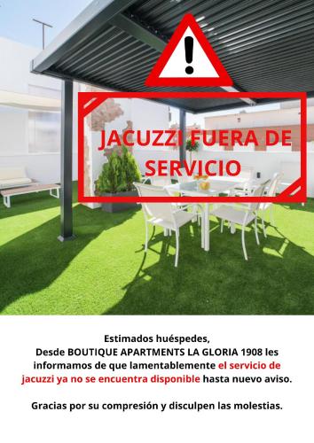 a sign on a building with a table and chairs at BOUTIQUE APARTMENTS- LA GLORIA 1908 in Almería