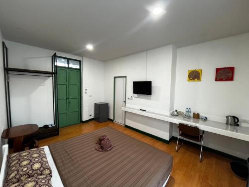 a bedroom with a teddy bear sitting on the floor at Goodmorning by Tamarind in Phra Nakhon Si Ayutthaya