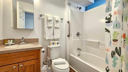 a bathroom with a toilet and a sink and a shower at 2413 Kuhio in Honolulu