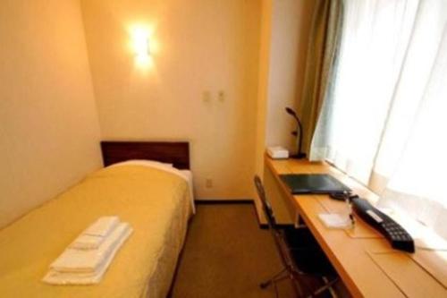 Postel nebo postele na pokoji v ubytování Comfesta Inn Kabe