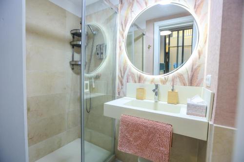 een badkamer met een wastafel en een spiegel bij Malaga Dreams Oldtown FREE PARKING by Easytrip in Málaga