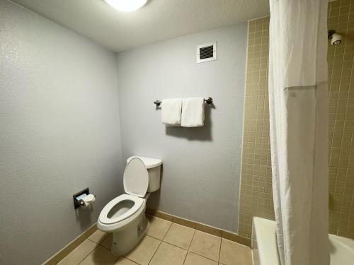 a bathroom with a toilet and a shower at Super 8 by Wyndham Dallas Love Field Airport in Dallas