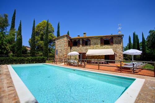 a villa with a swimming pool in front of a house at LA MAGIA 8&2, Emma Villas in Gavorrano