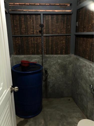 a shower in a bathroom with a large blue barrel at The Big House in Koh Chang Ranong