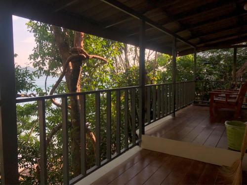 a balcony of a house with a tree at The Big House in Koh Chang Ranong
