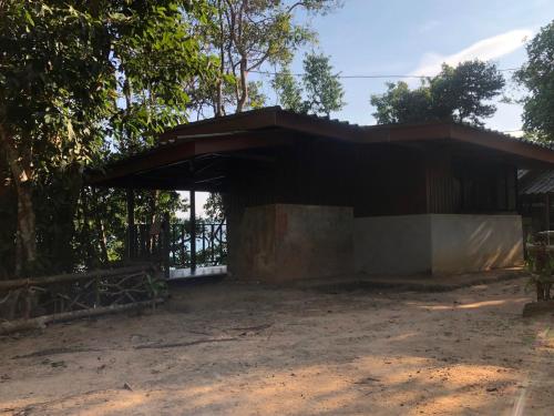 a building that is sitting in the dirt at The Big House in Koh Chang Ranong