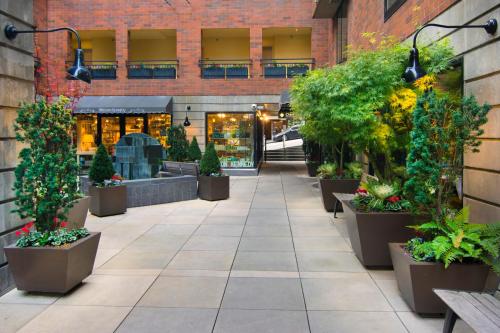 a courtyard with potted plants and a building at Inn at the Market in Seattle