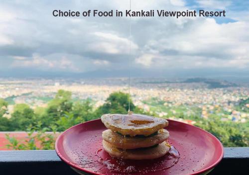 a red plate with a stack of food in kombat respawn resort at Kankali Viewpoint Resort Pvt Ltd in Kathmandu