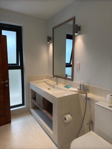 a bathroom with a sink and a mirror at Maharani Apartments in Diani Beach