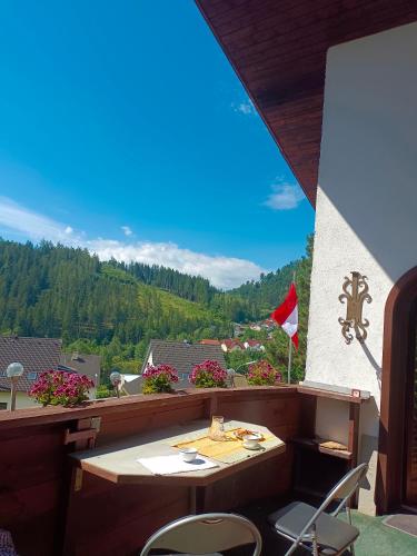 a table and chairs on a balcony with a view at Sepp's holiday apartment in Kapfenberg